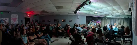 A packed house facing the stage