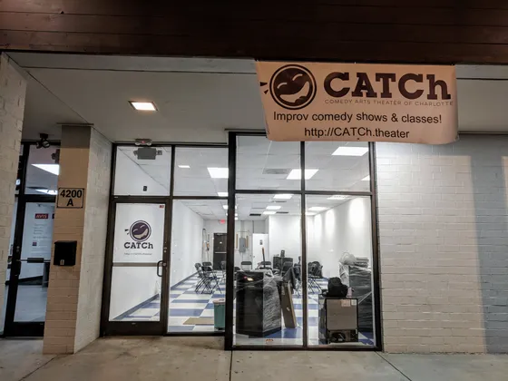 The CATCh storefront at night with its banner over the door