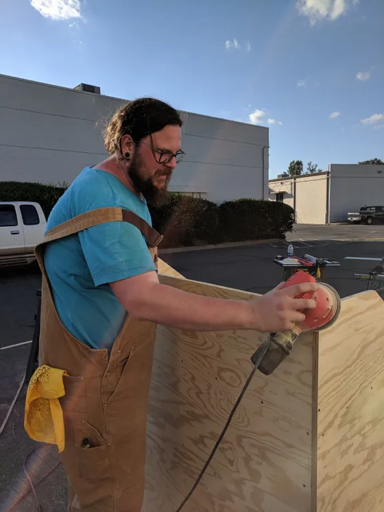 Volunteer cutting plywood with a circular saw