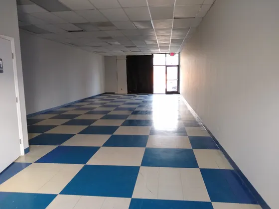 An empty space with a checkered floor before the build-out