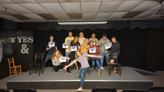 A cast posing together on the CATCh stage